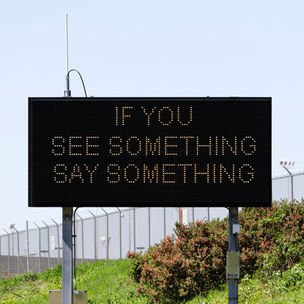 A billboard that reads "If you see something, say something"
