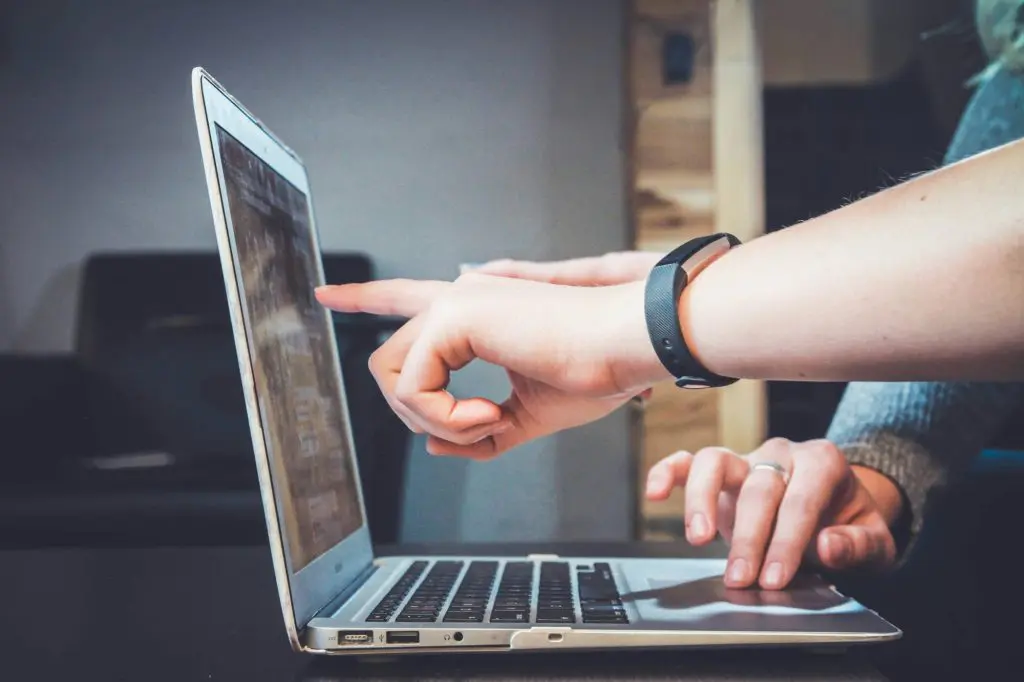 two people working on a computer together