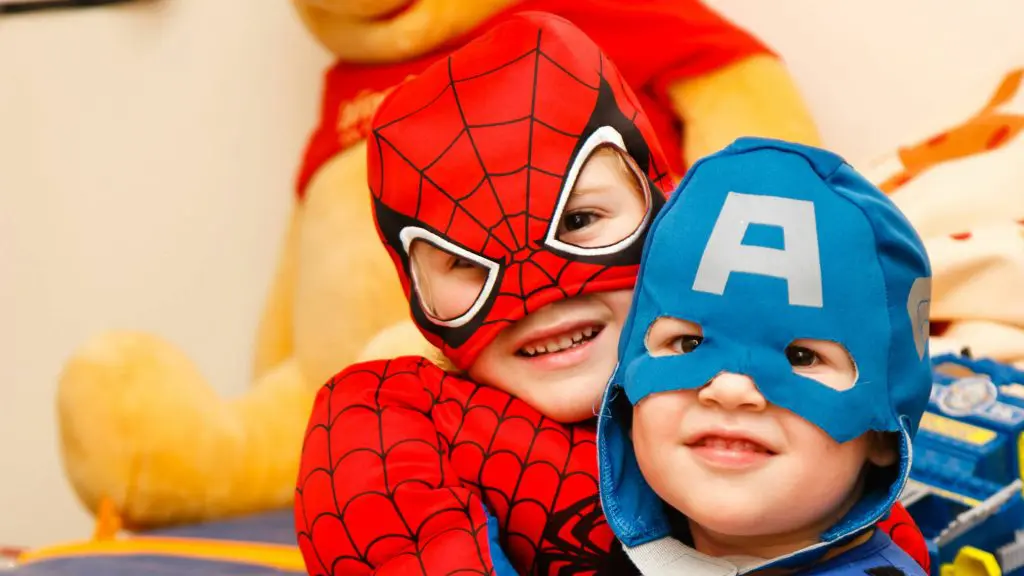 Two children in super hero costumes