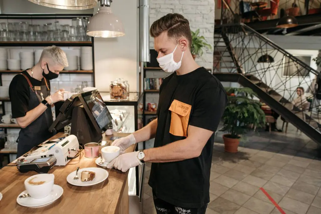 Workers at a coffee shop wearing masks