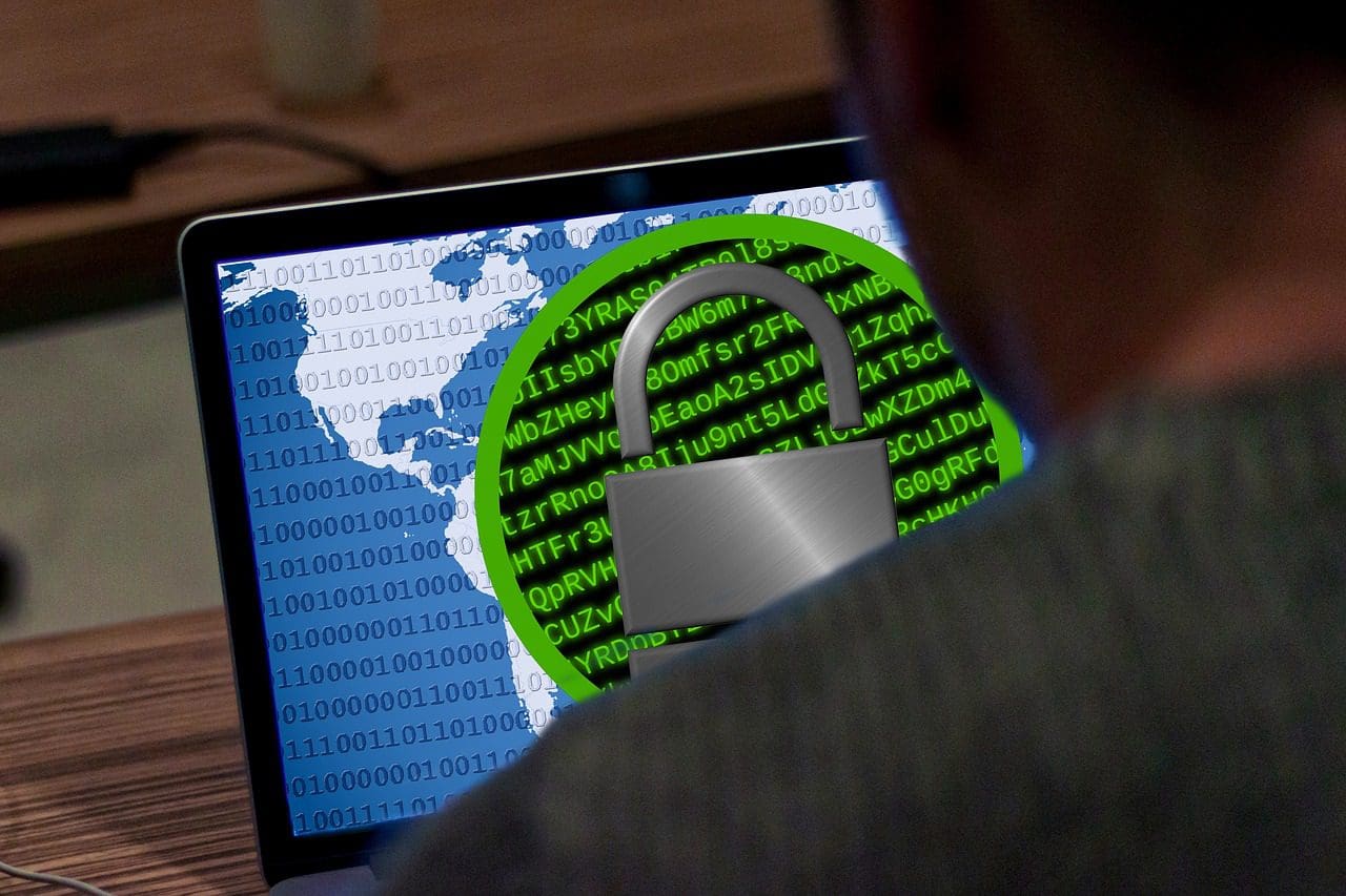 Person sitting in front of computer with padlock on screen