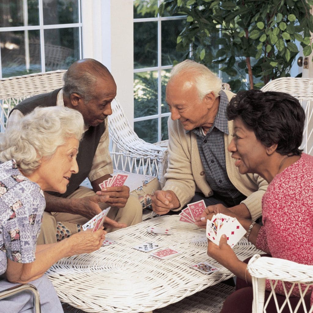 A group of older adults playing a card game
