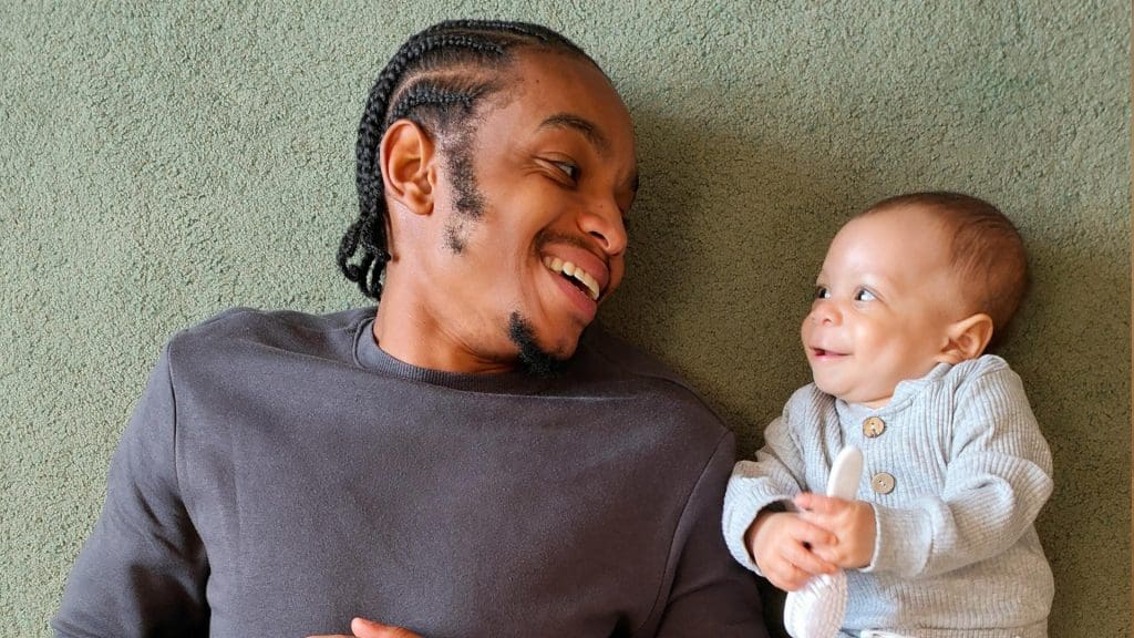 A father smiling at his baby