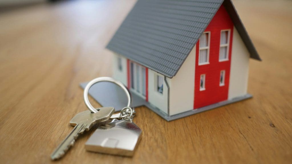 A tiny home and a set of keys on a table