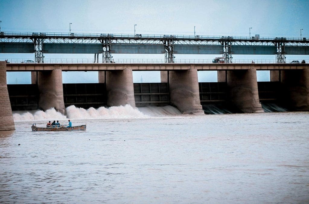 A dam on a river with a boat in front of it
