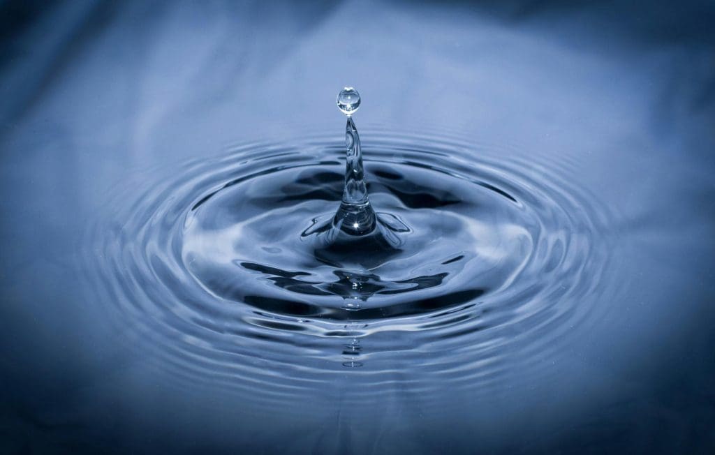 A drop of water into a pool of water causing ripples