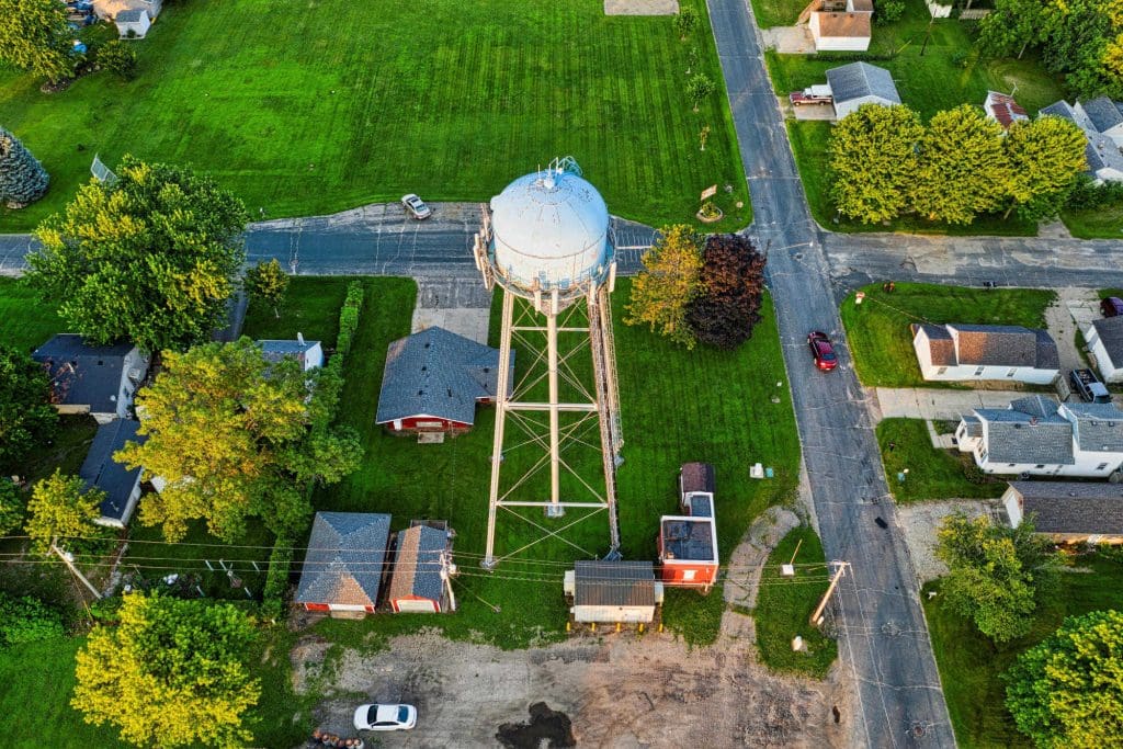 An aerial shot of a watertower in a small town